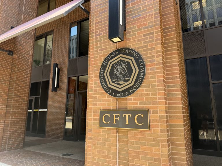 Horizontal close-up photo of CFTC signage on brick building